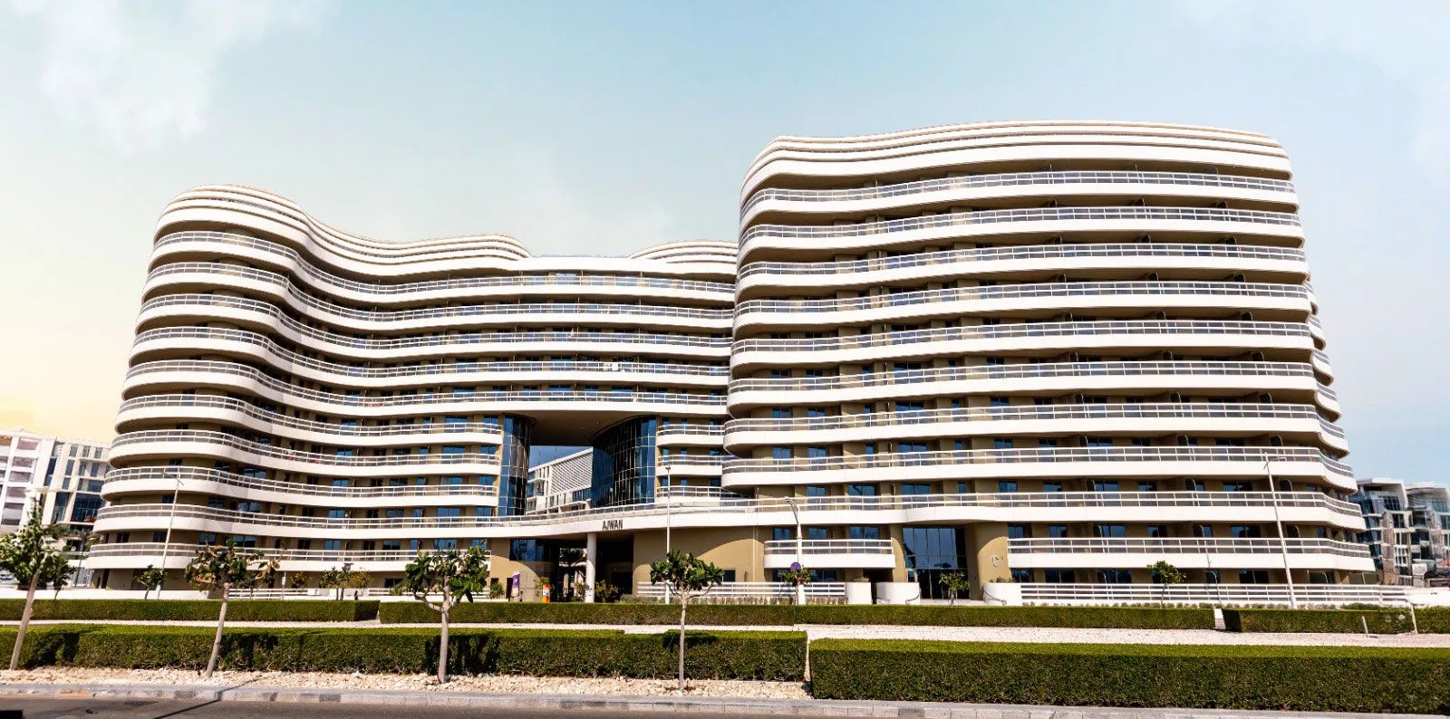 Contemporary architecture of Ajwan Towers with smooth curves inspired by the natural beauty of the Grand Canyon.